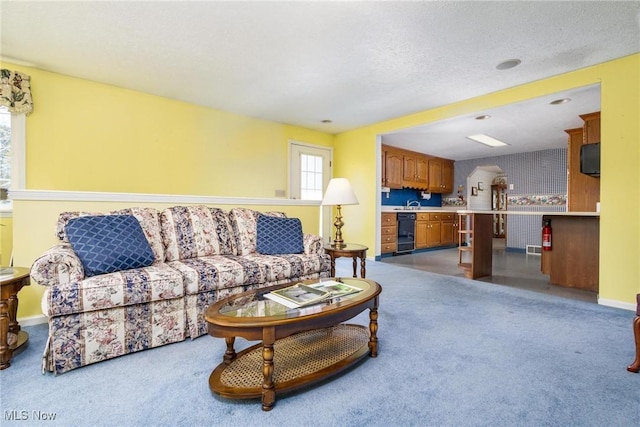 living room with baseboards, arched walkways, and carpet