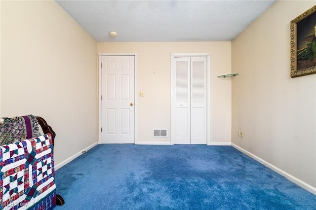 unfurnished bedroom featuring carpet flooring, baseboards, and visible vents
