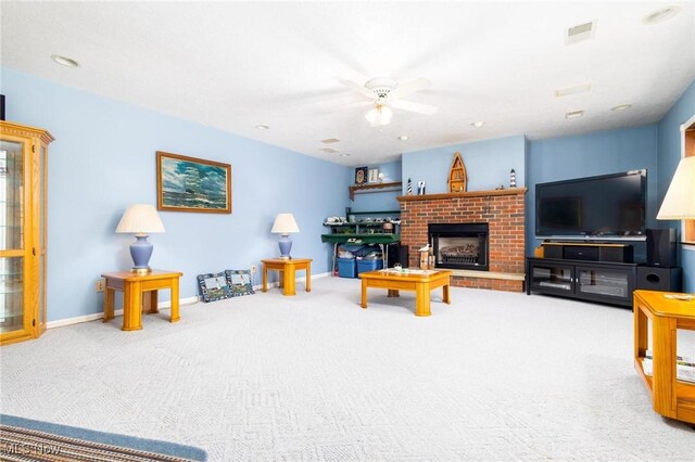 carpeted living area with recessed lighting, a fireplace, ceiling fan, visible vents, and baseboards