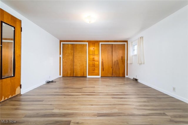 265 Putnam Ln, Weirton, WV 26062 - unfurnished bedroom with two closets, light wood finished floors, and baseboards