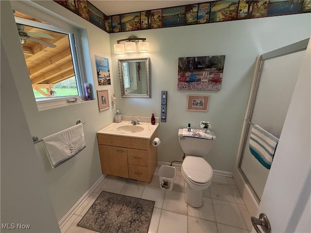bathroom with baseboards, toilet, a shower with shower door, vanity, and a ceiling fan