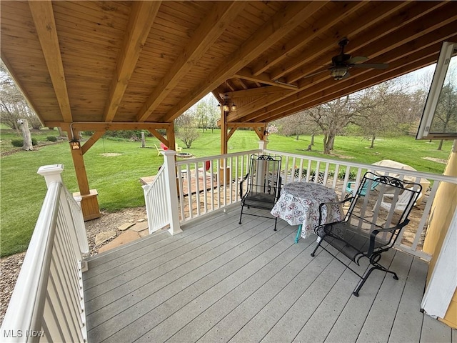 deck featuring a lawn and a ceiling fan
