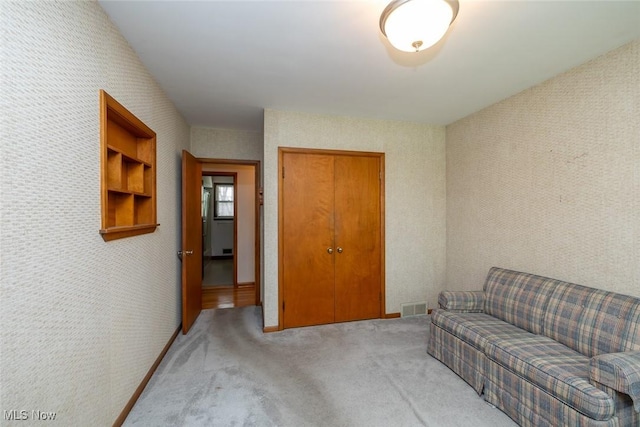 carpeted living area with visible vents