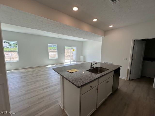 414 Honeycrisp Dr NE, Louisville, OH 44641 - kitchen with a sink, wood finished floors, stainless steel dishwasher, an island with sink, and recessed lighting