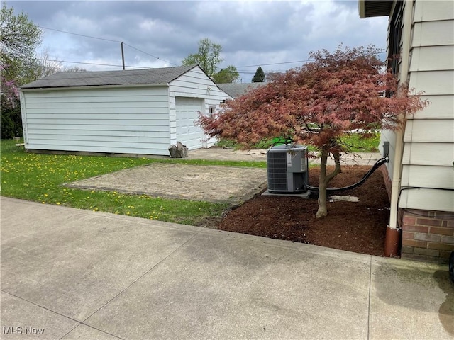 view of yard with cooling unit and an outbuilding