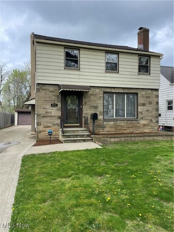 view of front facade featuring a chimney, a front yard, and stone siding