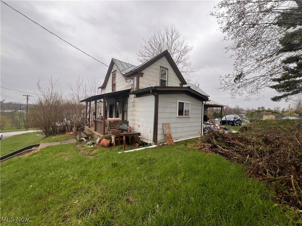view of property exterior with a yard
