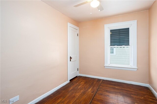 9612 Park Heights Ave, Garfield Heights, OH 44125 - spare room featuring a ceiling fan, dark wood-style flooring, and baseboards