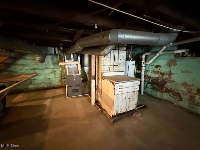 unfinished below grade area with heating unit and gas water heater