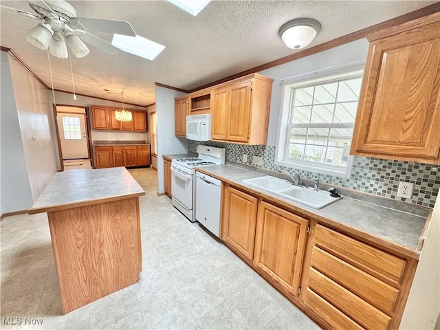kitchen with ornamental molding, a sink, tasteful backsplash, and white appliances