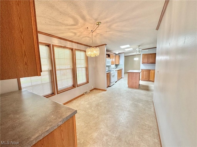 kitchen featuring a textured ceiling, visible vents, brown cabinets, and ornamental molding