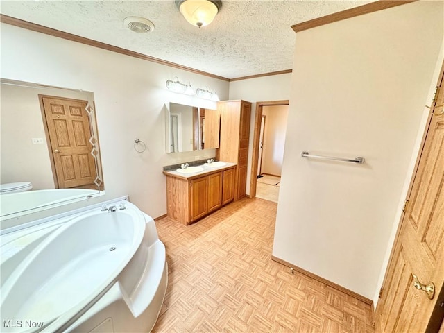 bathroom with a textured ceiling, baseboards, a bath, ornamental molding, and vanity