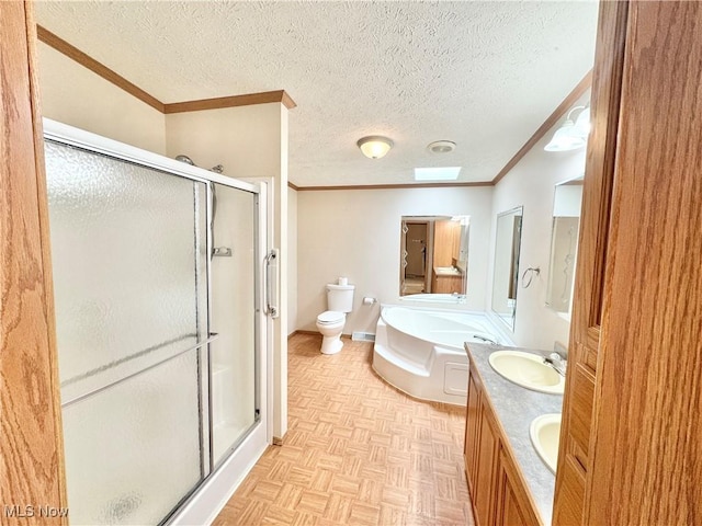 bathroom with a shower stall, crown molding, a sink, toilet, and a garden tub