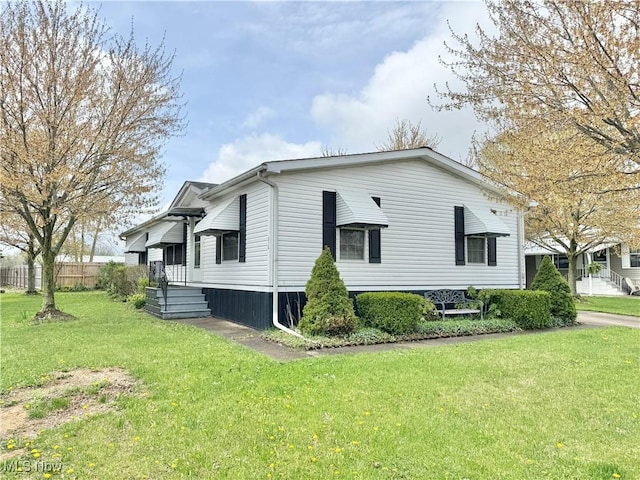 view of home's exterior featuring a yard and fence