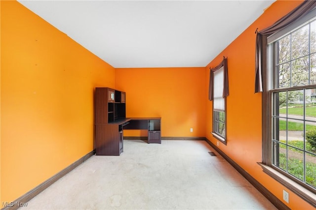 unfurnished office featuring baseboards, visible vents, and carpet