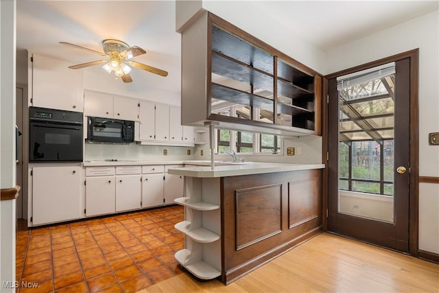kitchen with open shelves, light countertops, black appliances, ceiling fan, and white cabinetry
