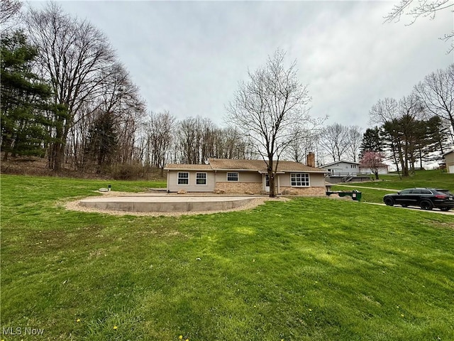 83 Oneida Trl, Malvern, OH 44644 - back of property with a lawn and a chimney