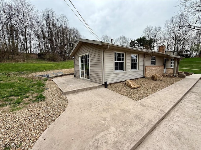 83 Oneida Trl, Malvern, OH 44644 - back of house featuring a chimney, a yard, and brick siding