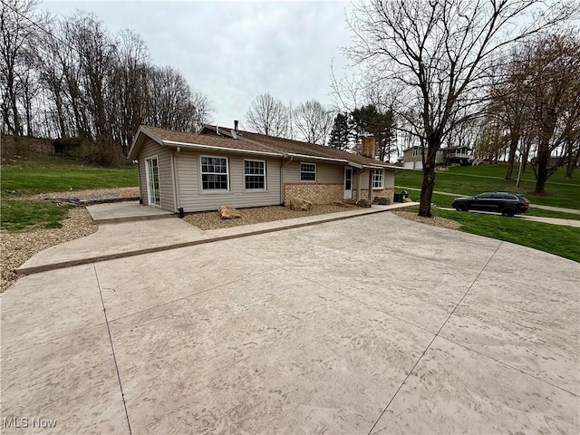 83 Oneida Trl, Malvern, OH 44644 - view of front of home featuring a front lawn, driveway, and a chimney