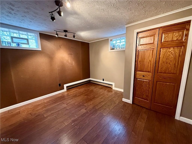 83 Oneida Trl, Malvern, OH 44644 - basement with wood finished floors, a healthy amount of sunlight, crown molding, and baseboards