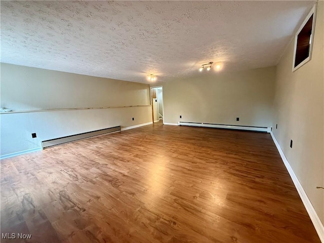 83 Oneida Trl, Malvern, OH 44644 - spare room with a textured ceiling, wood finished floors, and a baseboard radiator