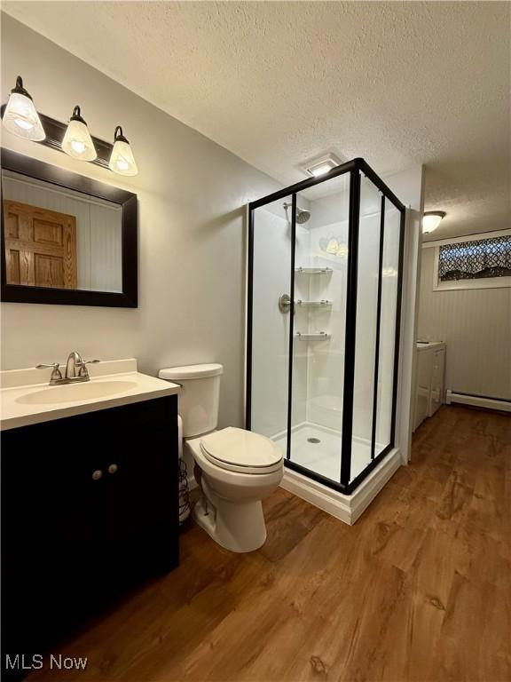 83 Oneida Trl, Malvern, OH 44644 - full bathroom featuring a textured ceiling, a shower stall, and wood finished floors