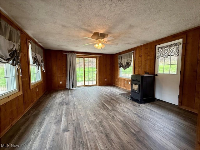 83 Oneida Trl, Malvern, OH 44644 - unfurnished living room with a textured ceiling, ceiling fan, wood finished floors, and plenty of natural light