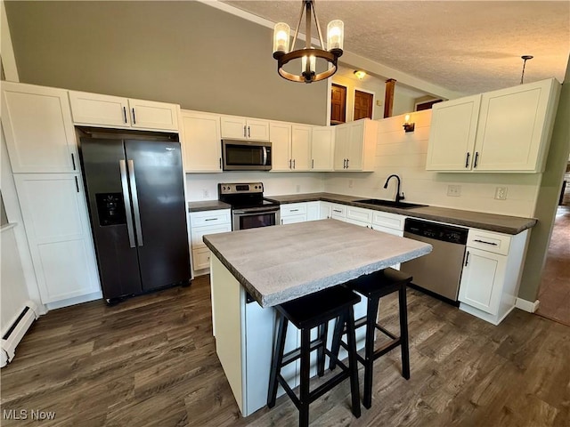 83 Oneida Trl, Malvern, OH 44644 - kitchen with appliances with stainless steel finishes, dark wood-style flooring, a notable chandelier, and a sink