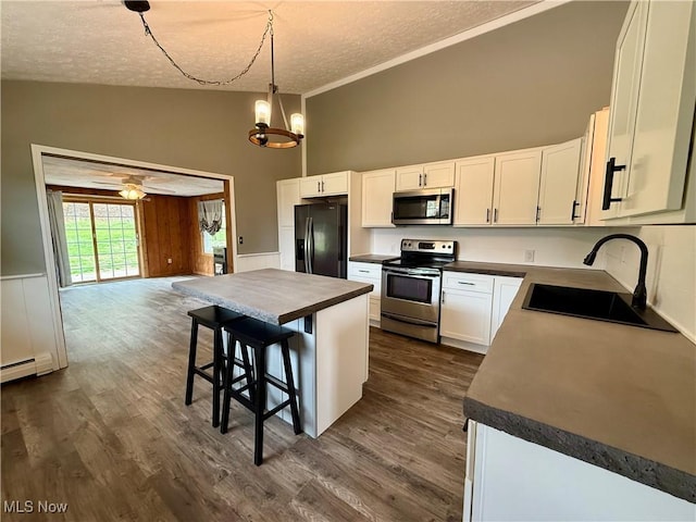 83 Oneida Trl, Malvern, OH 44644 - kitchen with appliances with stainless steel finishes, dark countertops, high vaulted ceiling, and a sink
