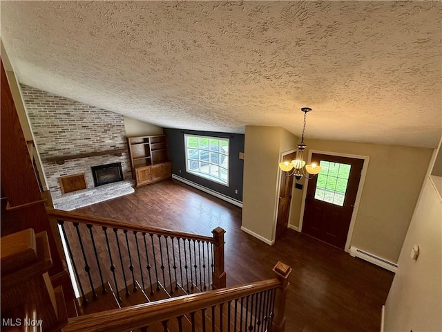 83 Oneida Trl, Malvern, OH 44644 - entryway with a baseboard heating unit, a textured ceiling, wood finished floors, and a chandelier