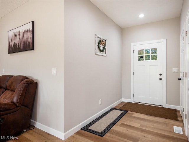 foyer with baseboards, visible vents, wood finished floors, and recessed lighting
