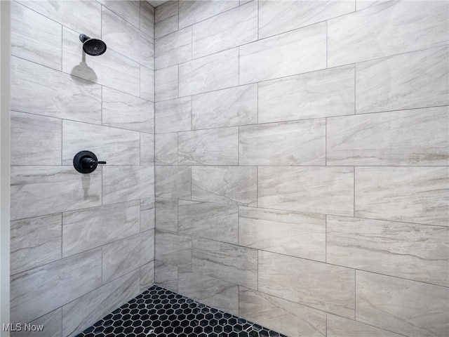 bathroom with tiled shower
