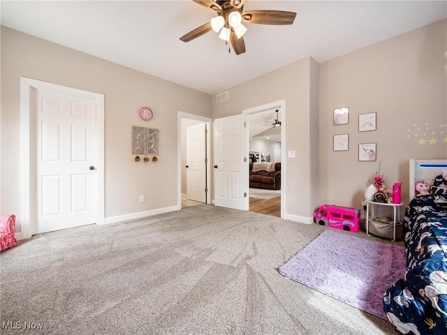 carpeted bedroom with visible vents, ceiling fan, and baseboards
