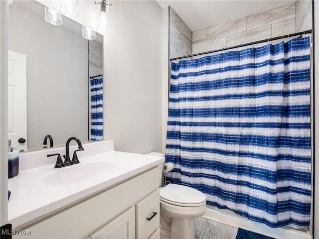 full bathroom featuring marble finish floor, toilet, a shower with curtain, and vanity