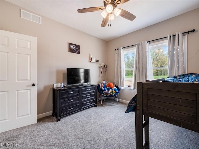 bedroom with visible vents, ceiling fan, baseboards, and light carpet