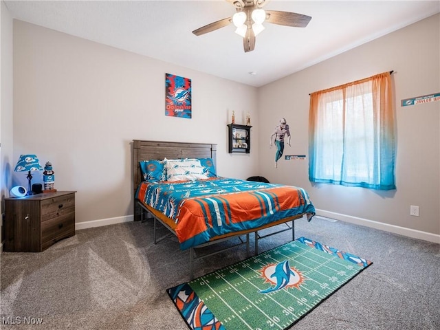 carpeted bedroom with ceiling fan and baseboards