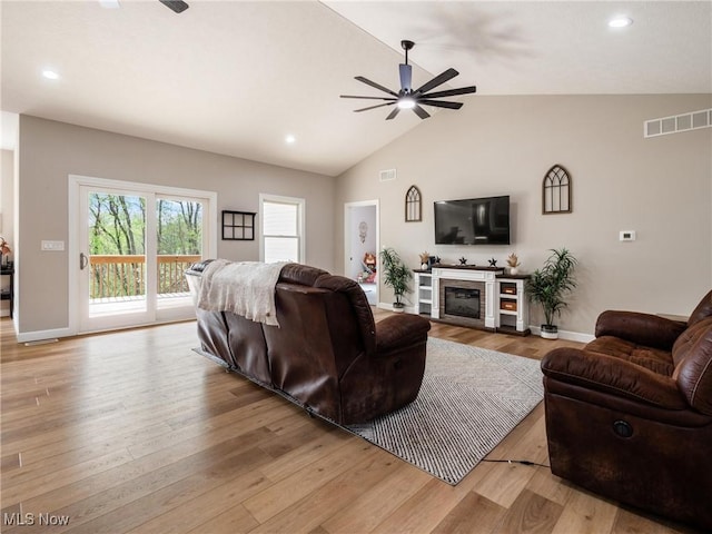 living area featuring recessed lighting, ceiling fan, lofted ceiling, and visible vents