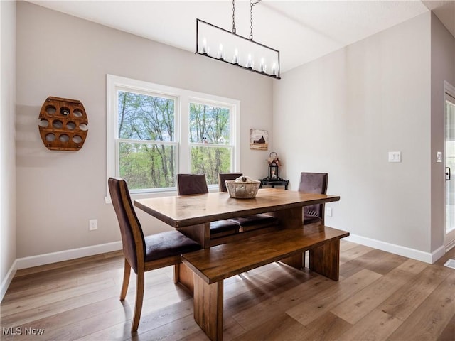 dining room featuring baseboards and light wood-style floors