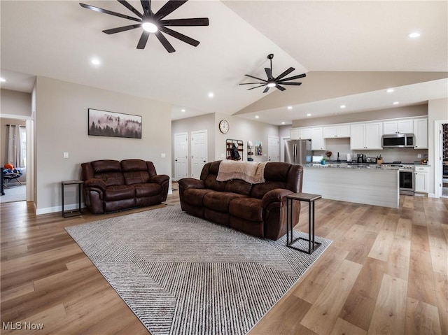living area with baseboards, light wood-type flooring, a ceiling fan, and recessed lighting