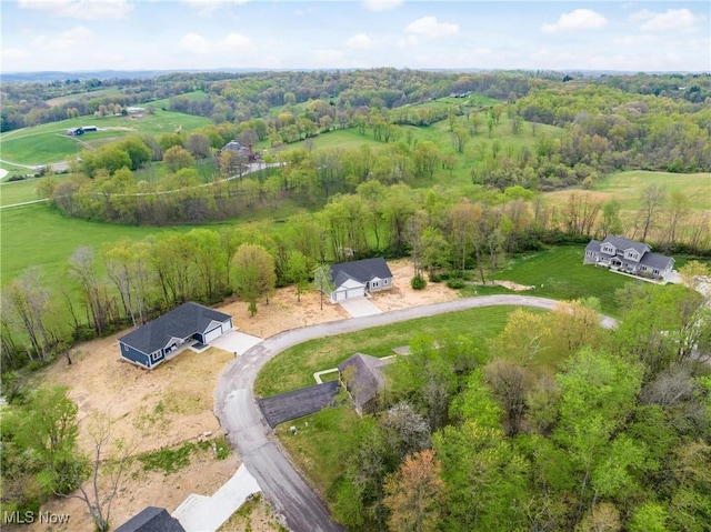 aerial view featuring a wooded view