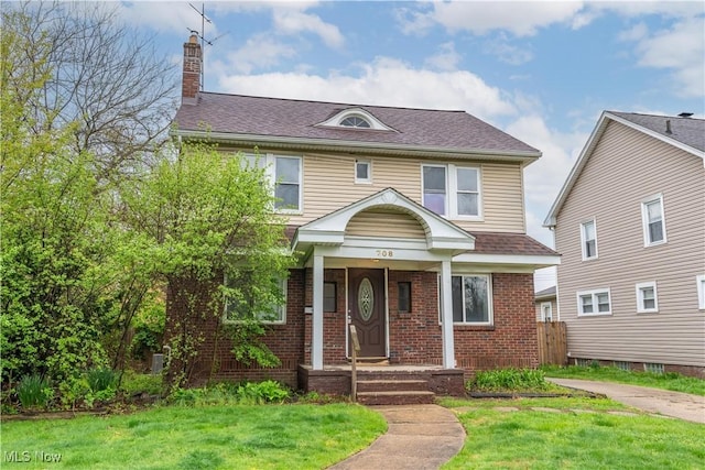 708 Moreley Ave, Akron, OH 44320 - view of front of property with a chimney, brick siding, a shingled roof, and a front lawn