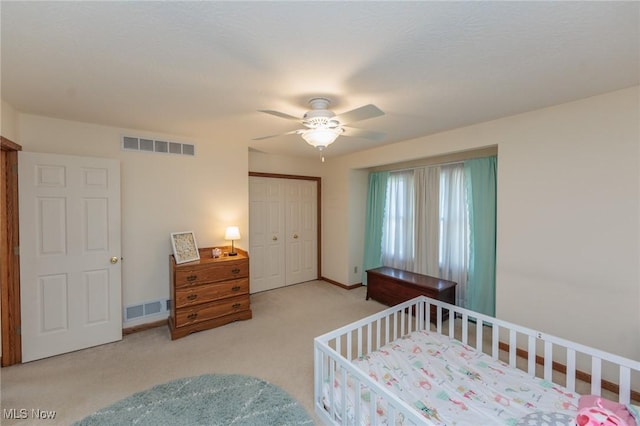 carpeted bedroom featuring visible vents, ceiling fan, baseboards, and a closet