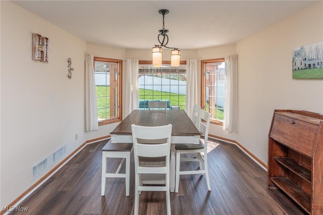 dining space with visible vents, dark wood-style flooring, and baseboards