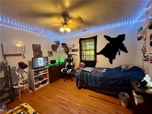 bedroom featuring light wood-type flooring and ceiling fan