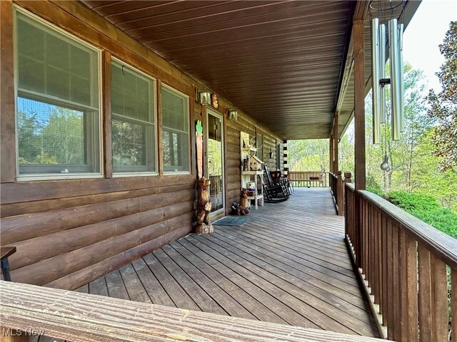 wooden terrace featuring covered porch