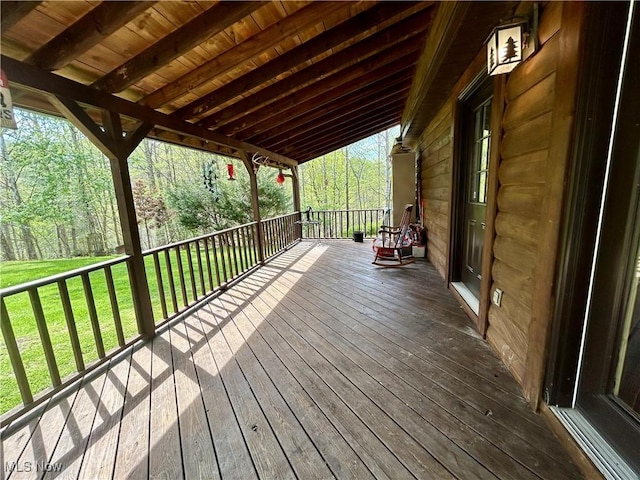 wooden terrace with a lawn
