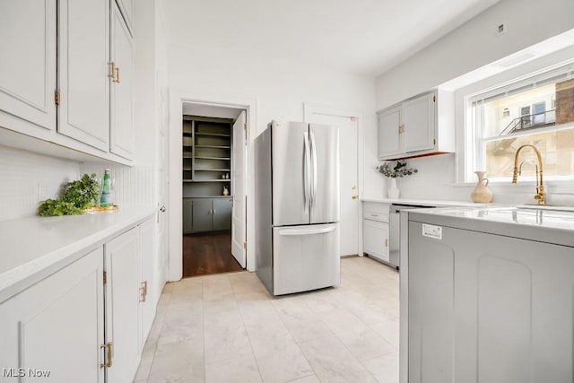 1357 E Blvd Unit 2, Cleveland, OH 44106 - kitchen featuring tasteful backsplash, light countertops, and freestanding refrigerator