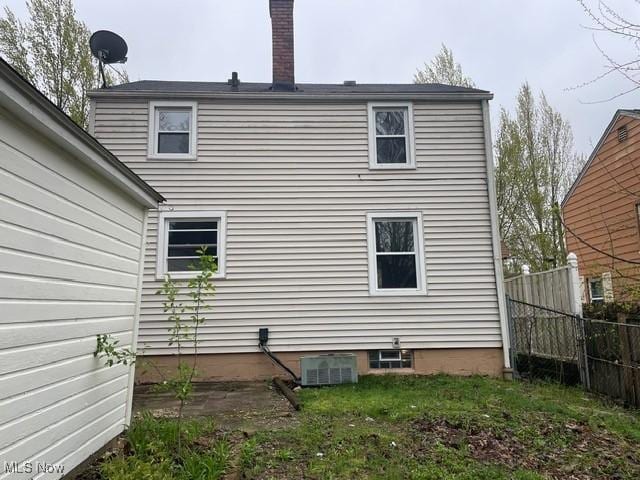1145 Arnold Ave, Akron, OH 44305 - rear view of property with a chimney, fence, and central AC unit