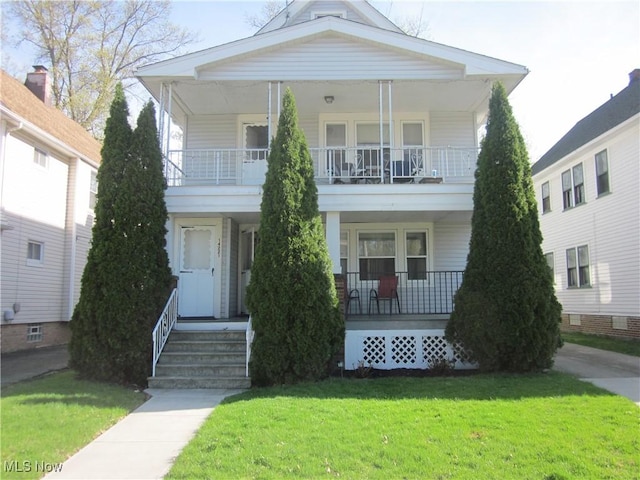 neoclassical / greek revival house featuring a porch, a front lawn, and a balcony