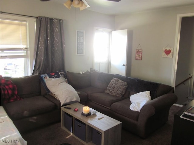carpeted living area featuring ceiling fan